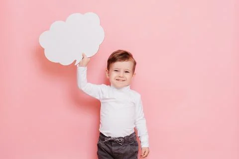 Studio portrait of a boy with a blank white board in the shape of a cloud Stock Photos