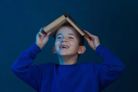 Studio portrait of boy on a blue background in a classic t-shirt. Stock Photos