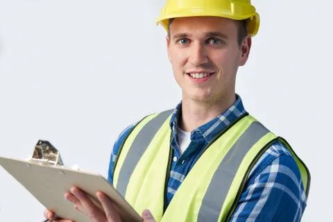 Studio Portrait Of Builder Architect With Clipboard Against White Background Stock Photos