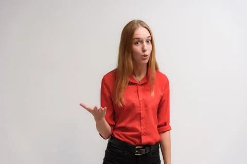 Studio portrait on the camera of a smiling beautiful girl with long hair talk Stock Photos