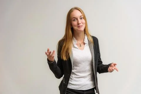 Studio portrait on the camera of a smiling beautiful girl with long hair talk Stock Photos