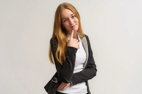 Studio portrait on the camera of a smiling beautiful girl with long hair talk 스톡 사진