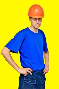 Studio portrait of a confident worker in a construction helmet looking at the Stock-Fotos
