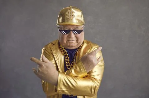 Studio portrait of cool senior man in thug life sunglasses and golden party Stock Photos