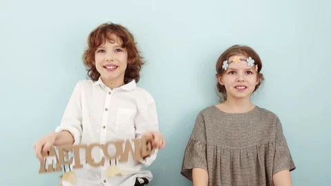 Studio portrait of cute school children with wooden signs. Spring holidays Stock Footage 101736069