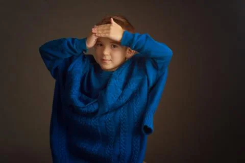 Studio portrait of dark-haired boy with a short haircut in a blue t-shirt and Stock Photos