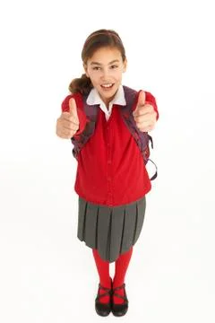 Studio Portrait Of Female Student In Uniform With Backpack Stock Photos