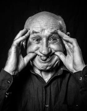 Studio portrait of a grandfather teasing 写真素材
