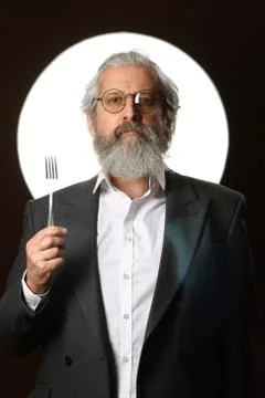 Studio portrait of a gray-haired elderly man with a shaggy mustache and beard Stock Photos