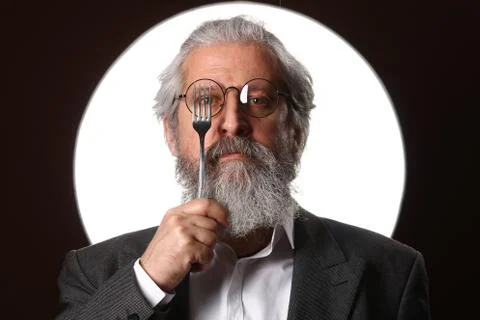 Studio portrait of a gray-haired elderly man with a shaggy mustache and beard Stock Photos