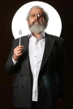 Studio portrait of a gray-haired elderly man with a shaggy mustache and beard Stock Photos