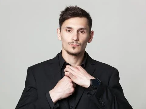 Studio portrait of handsome elegant young man in black  clothes posing. Foto stock
