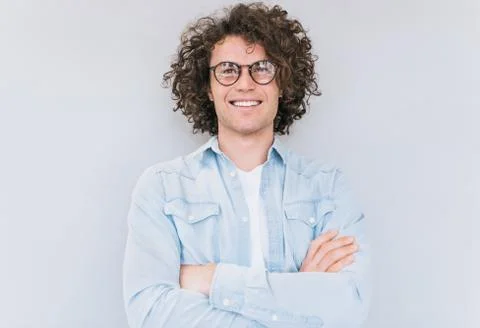 Studio portrait of handsome smart-looking smiling male posing for advertiseme Stock Photos