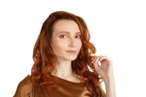Studio portrait of a middle age red-haired woman over white 库存照片