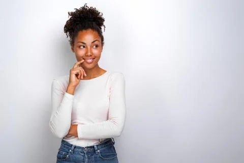Studio portrait of a playfully pose mulatto girl touching herself face by ind Stock Photos