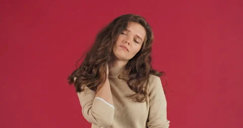 Studio portrait on red background young girl sad caucasian model woman stands Stock Footage 148435633