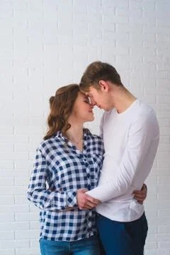 Studio Portrait Of Romantic Young Couple Embracing on a White Background Stock Photos