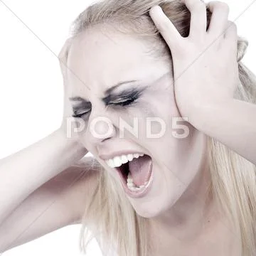 Studio portrait of a screaming young blond woman Stock Photos