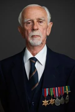 Studio Portrait Of Senior Man Wearing Medals Stock Photos