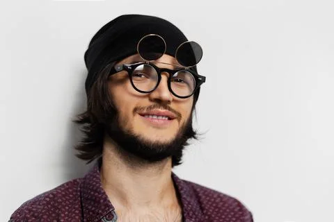 Studio portrait of smiling guy on white background. Wearing round glasses. Stock Photos