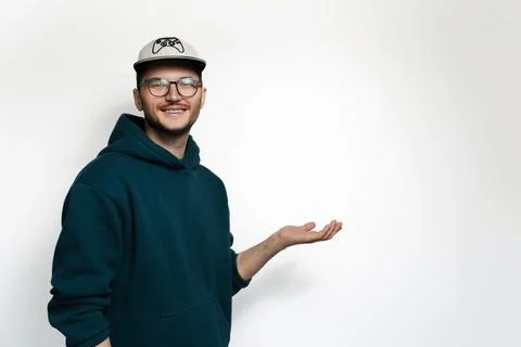 Studio portrait of smiling young man hold empty space on white background. Stock Photos