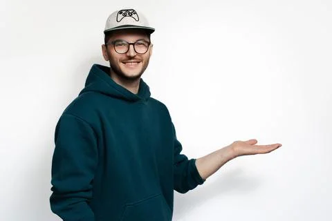Studio portrait of smiling young man hold empty space on white background. Stock Photos