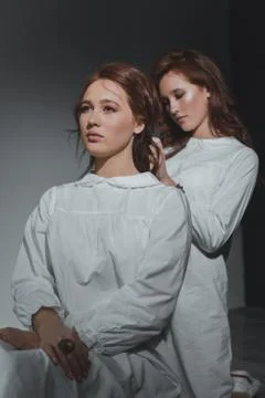 Studio portrait of two red-haired twin girls. Stock Photos
