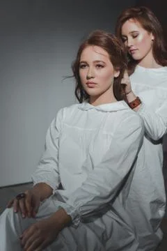 Studio portrait of two red-haired twin girls. Stock Photos