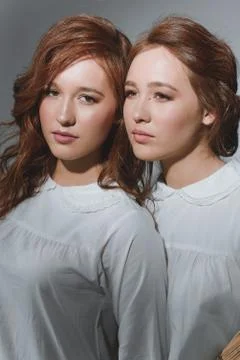 Studio portrait of two red-haired twin girls. Stock Photos