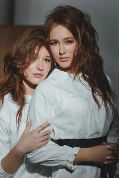 Studio portrait of two red-haired twin girls. Stock Photos