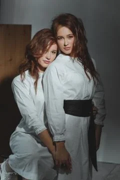Studio portrait of two red-haired twin girls. Stock Photos