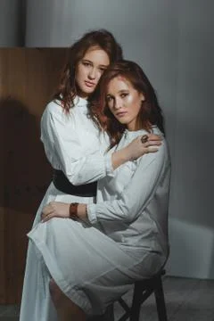 Studio portrait of two red-haired twin girls. Stock Photos