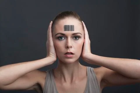 Studio portrait of woman with bar code on forehead Stock-Fotos