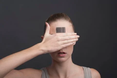 Studio portrait of woman with bar code on forehead Stock-Fotos