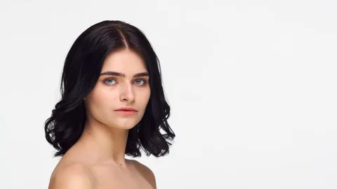 Studio portrait of young and beautiful brunette woman over isolated white Video stock 126690622