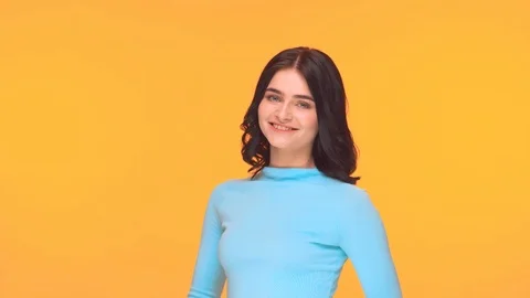 Studio portrait of young and expressive teenage girl over yellow background. Stock Footage 125191119