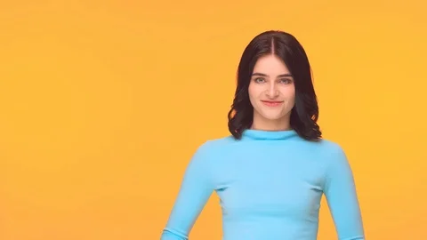 Studio portrait of young and expressive teenage girl over yellow background. Stock Footage 125191131
