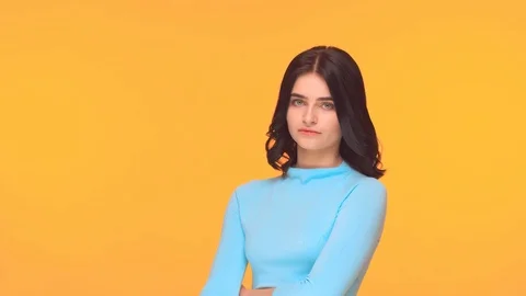 Studio portrait of young and expressive teenage girl over yellow background. Video stock 125736550