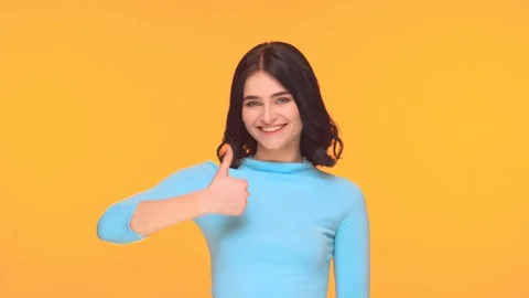 Studio portrait of young and expressive teenage girl over yellow background. Stock Footage 126494064