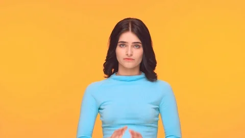 Studio portrait of young and expressive teenage girl over yellow background. Video stock 126690651