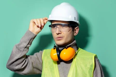 Studio portrait of young builder man, engineer. Stock Photos