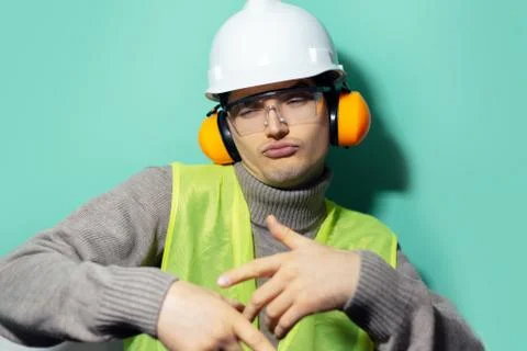 Studio portrait of young cool builder man, engineer dancing. Stock Photos