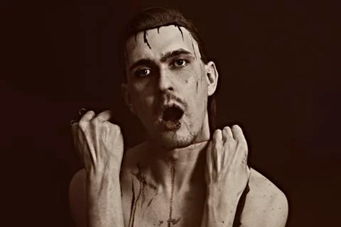 Studio portrait of a young man strangling himself thread Stock Photos
