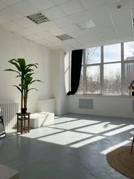 Studio room with large window and natural light Stock Photos