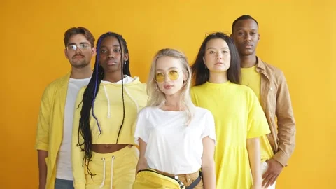 Studio shoot of encouraged models of diverse races isolated on yellow background Stock Footage 144424223