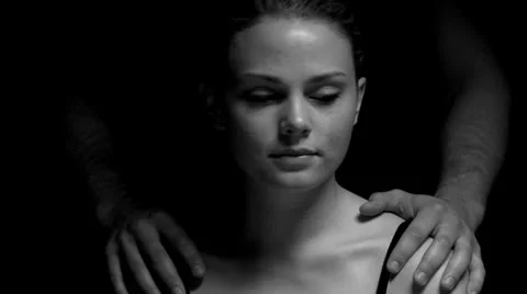 Studio shoot with man standing behind woman in black and white Stock Footage 22955068