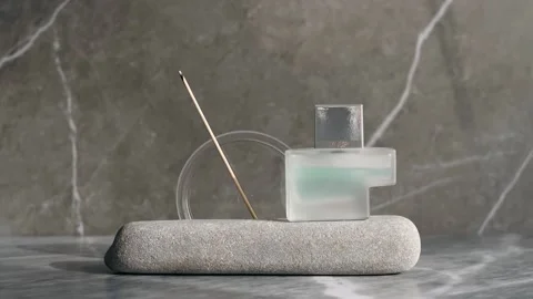 Studio shoot of perfume with rock Stock Footage 322202053