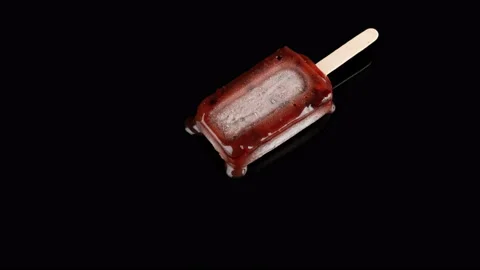 Studio shoot of red bean popsicle melting on black background timelapse 8K Stock Footage 90470015