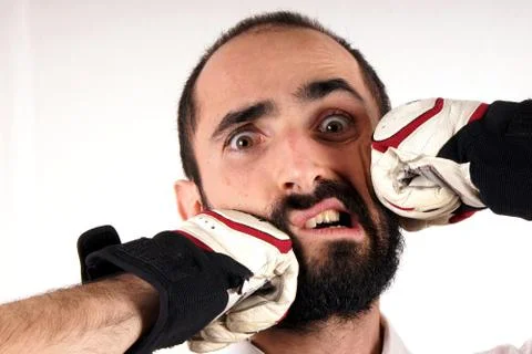 Studio shot of a beard man hit by punchs Stock Photos