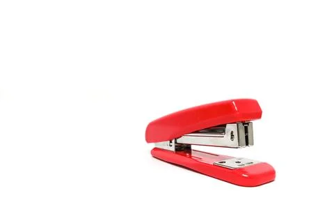 Studio shot of a bright red stapler isolated on a clean white background, r.. Stock Photos